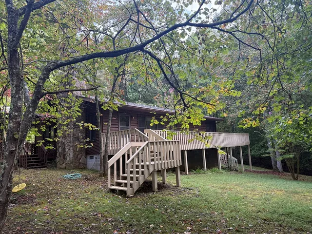 a view of a roof deck with wooden fence and wooden fence