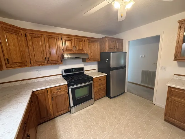 a kitchen with a refrigerator stove and sink