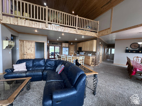 1940 East Shore Road St. Charles, ID 83272 - Photo 16 of 64 Carpeted living room with a high wood ceiling and recessed lighting