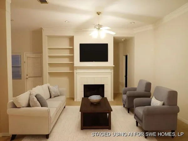 a living room with furniture a flat screen tv and a fireplace