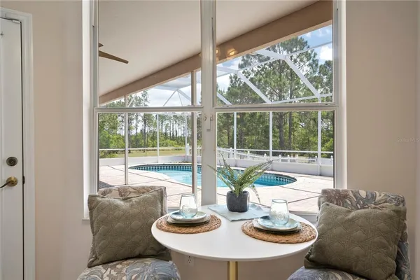 a spacious bedroom with a large bed and a chandelier