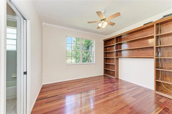 a bedroom with a large bed and a flat tv screen on dresser