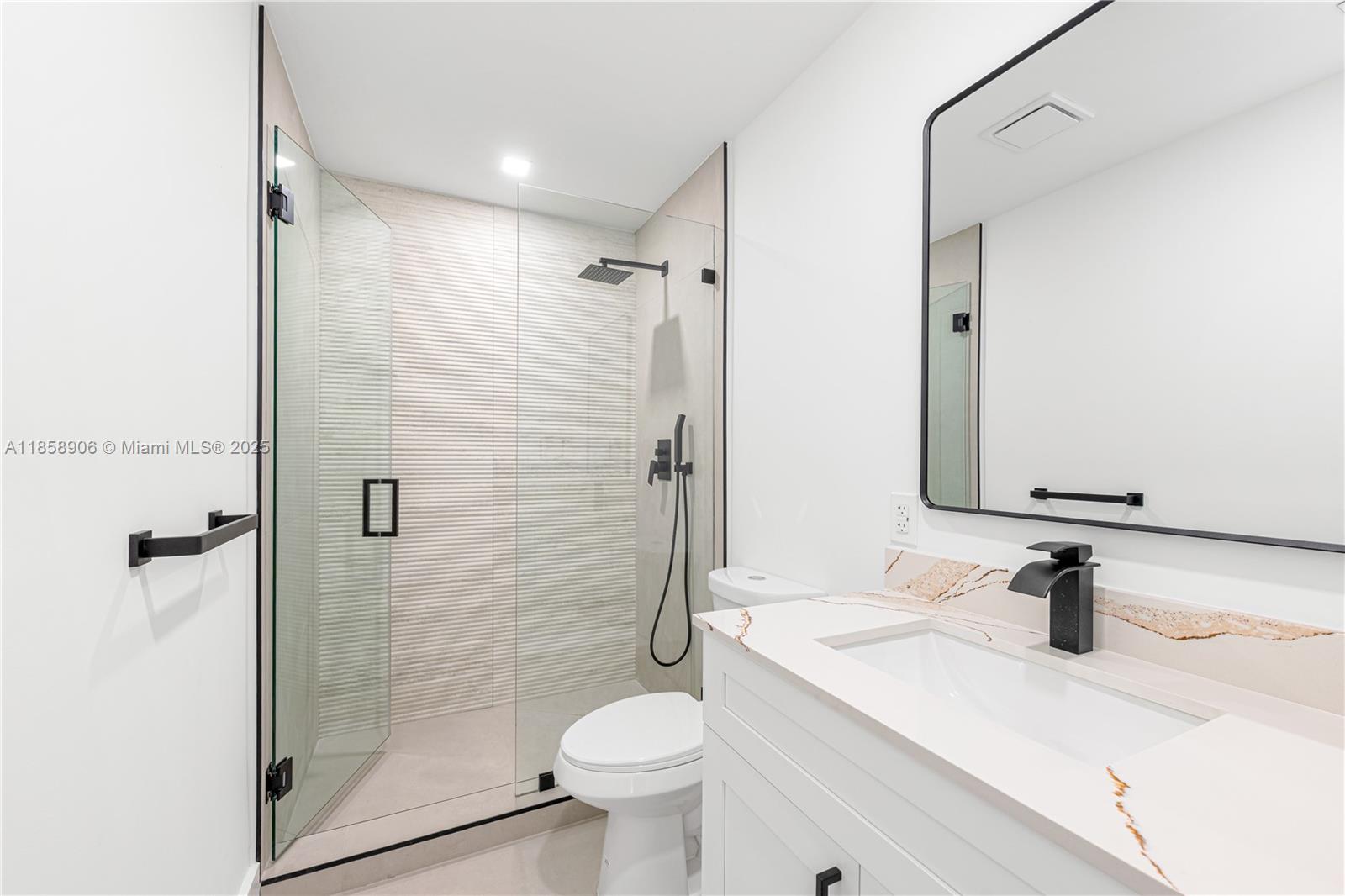 11835 Southwest 37th Street Miami, FL 33175 - Photo 24 of 47 a bathroom with a granite countertop sink toilet and shower
