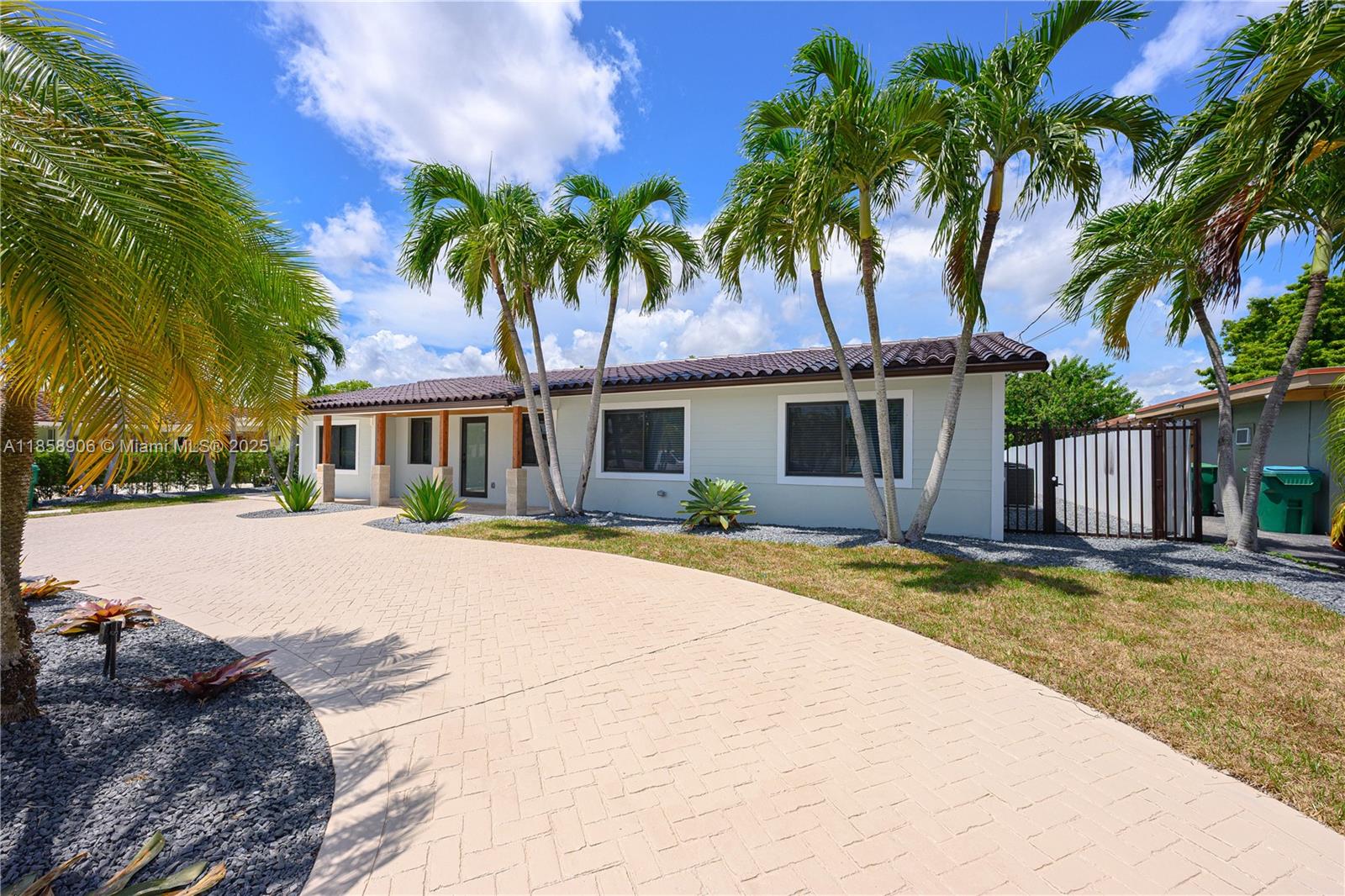 11835 Southwest 37th Street Miami, FL 33175 - Photo 3 of 47 a front view of a house with a garden and patio
