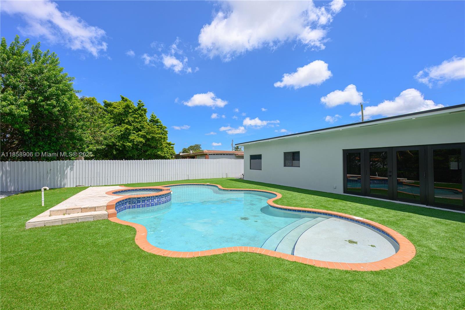 11835 Southwest 37th Street Miami, FL 33175 - Photo 36 of 47 a view of a house with swimming pool and a yard