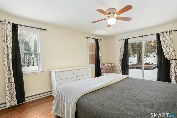 a bedroom with a large bed and a large window