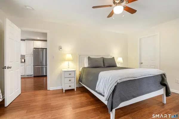 a bedroom with a bed and a chandelier