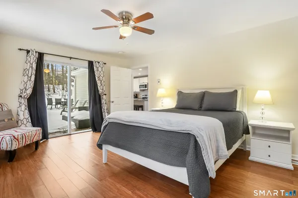 a bedroom with a large bed and a chandelier