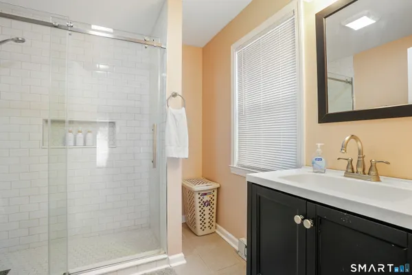 a bathroom with a sink vanity and a mirror