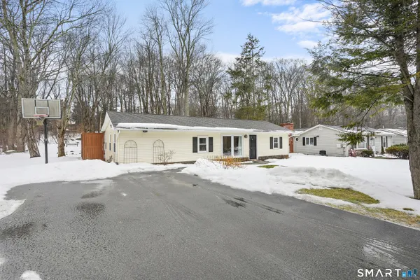 a view of a house with snow on the road