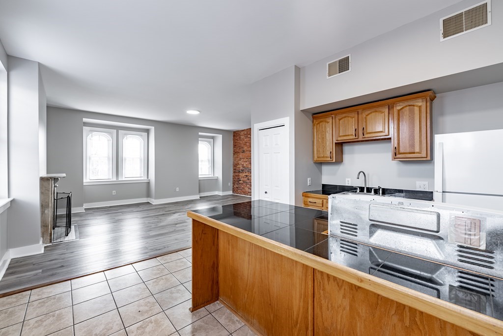 238-240 Union Street Springfield, MA 01105 - Photo 11 of 17 a large kitchen with stainless steel appliances a large counter top and a stove