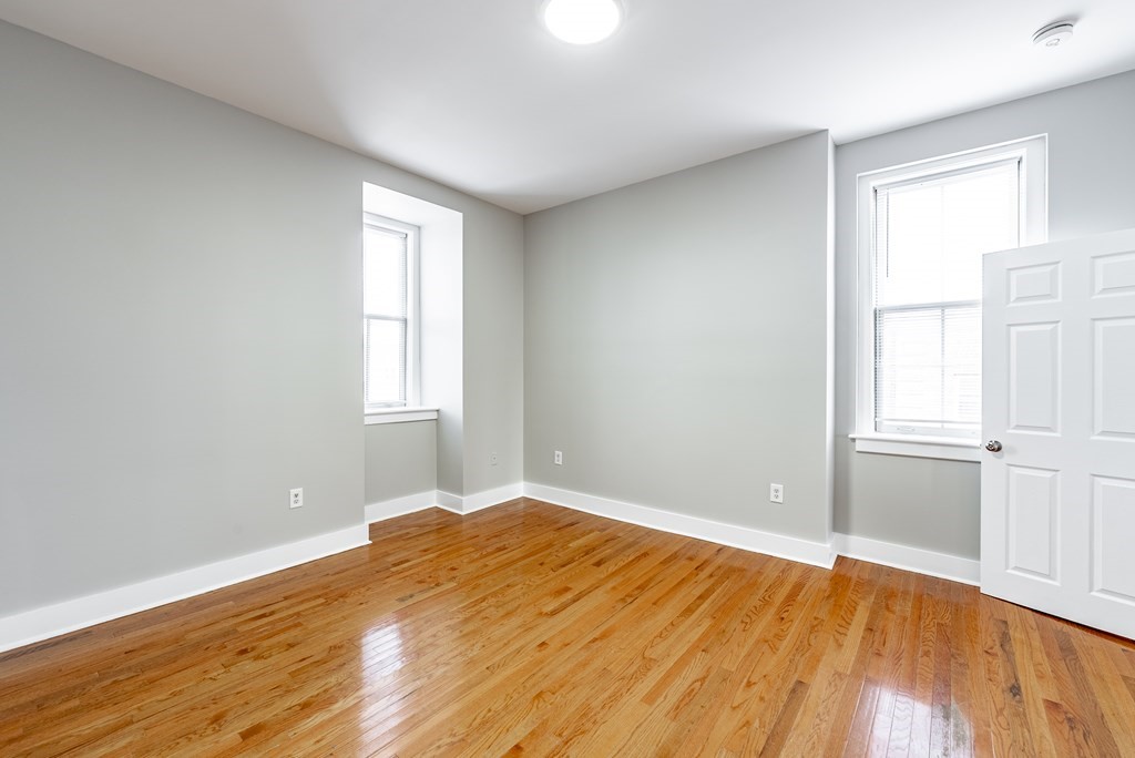 238-240 Union Street Springfield, MA 01105 - Photo 12 of 17 an empty room with wooden floor and windows