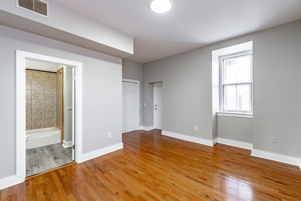 238-240 Union Street Springfield, MA 01105 - Photo 13 of 17 a view of empty room with wooden floor and fan