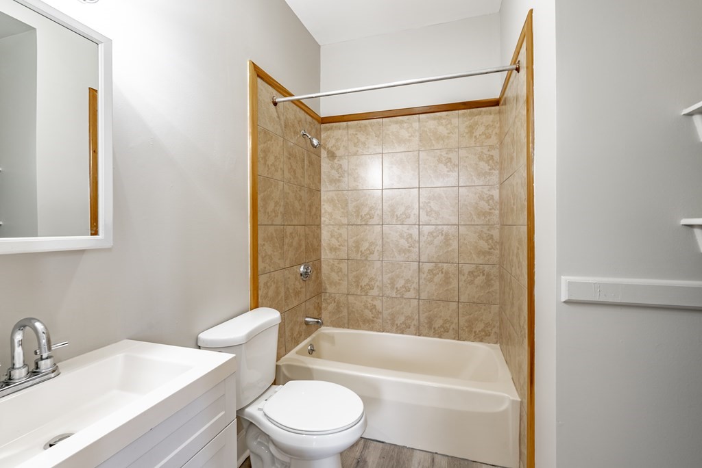 238-240 Union Street Springfield, MA 01105 - Photo 16 of 17 a bathroom with a bathtub shower sink vanity and toilet