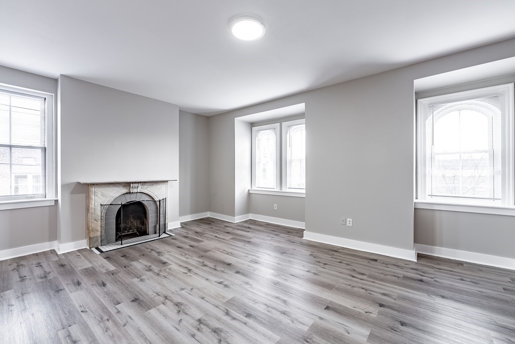 238-240 Union Street Springfield, MA 01105 - Photo 5 of 17 an empty room with fireplace and wooden floor
