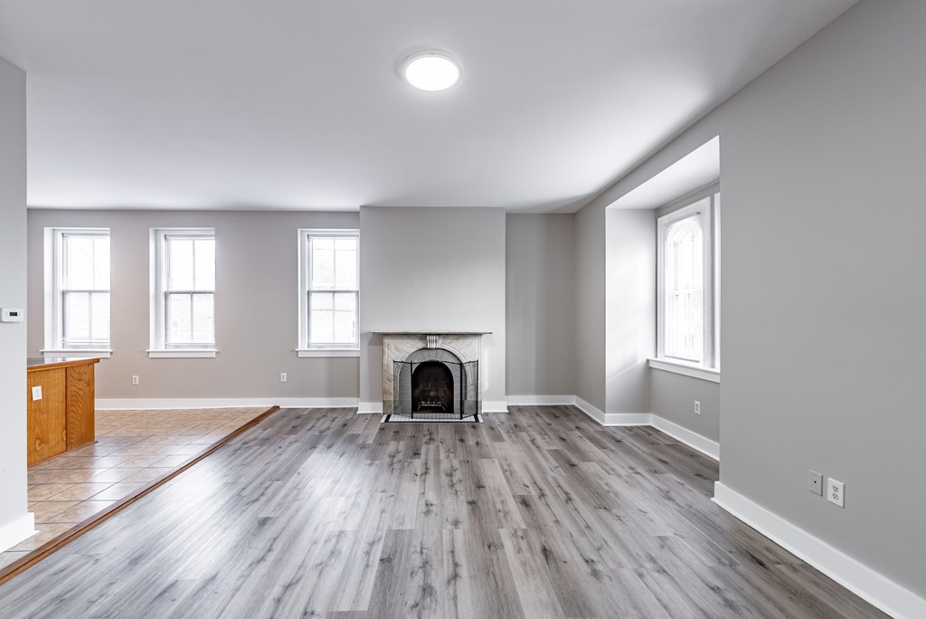 238-240 Union Street Springfield, MA 01105 - Photo 6 of 17 a view of a livingroom with wooden floor and a fireplace