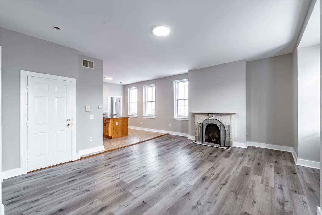 238-240 Union Street Springfield, MA 01105 - Photo 7 of 17 a view of a livingroom with wooden floor and a fireplace