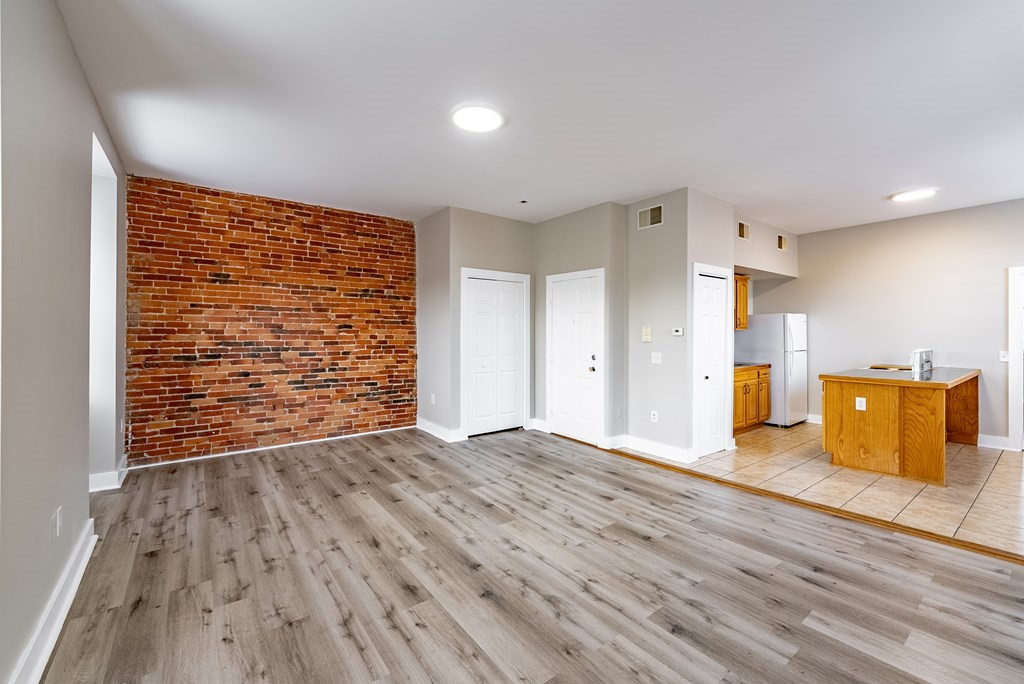 238-240 Union Street Springfield, MA 01105 - Photo 8 of 17 a view of an empty room with wooden floor and a kitchen