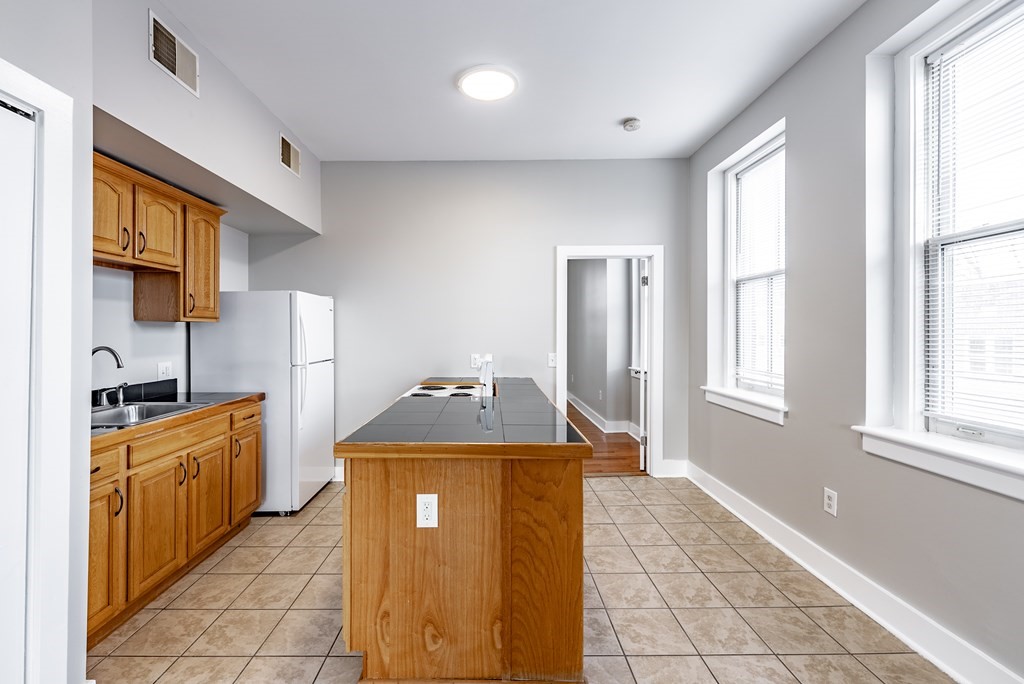 238-240 Union Street Springfield, MA 01105 - Photo 9 of 17 a kitchen with stainless steel appliances granite countertop a stove a sink and a refrigerator