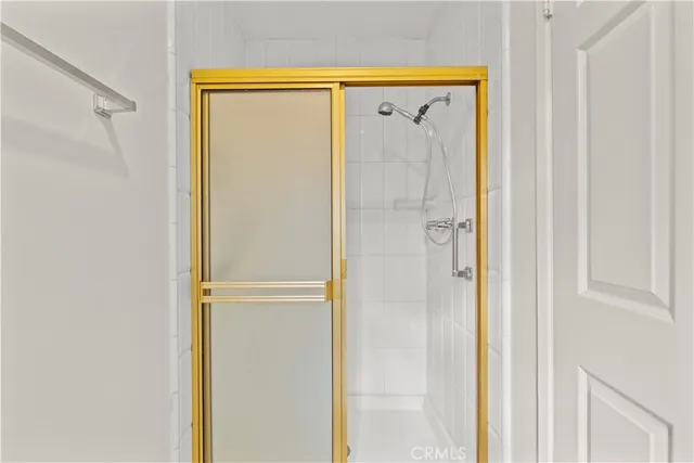 a bathroom with a glass shower door