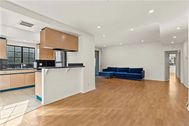 a view of kitchen and hall with wooden floor
