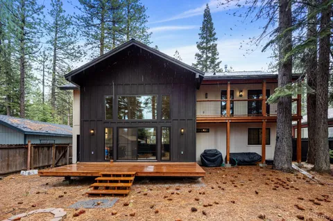 a backyard of a house with a large tree