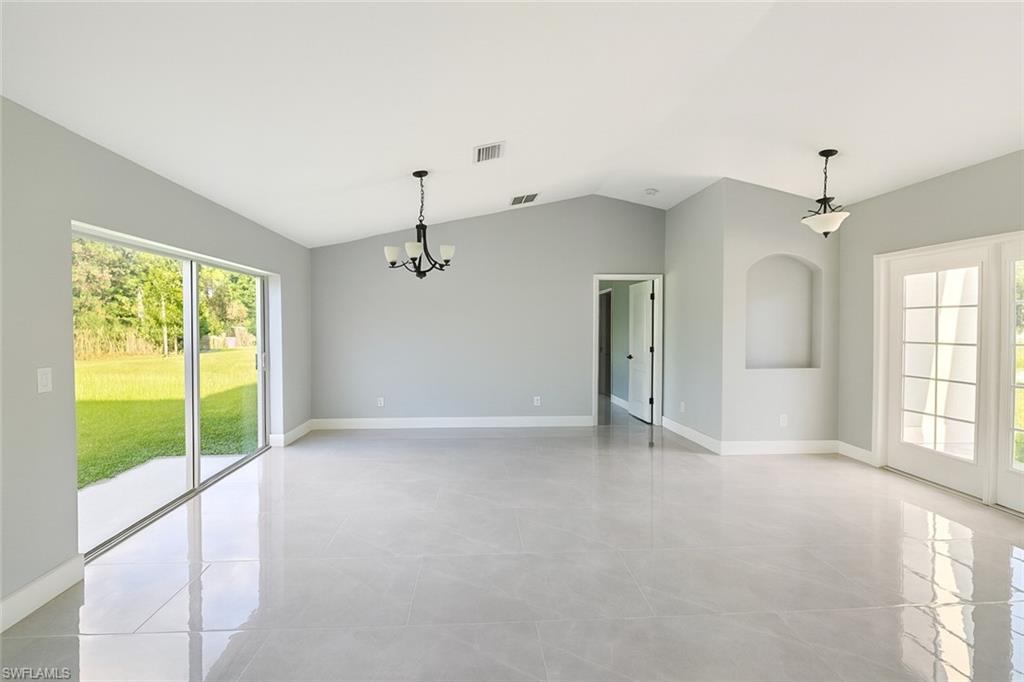 116 Ridgemont Drive Lehigh Acres, FL 33972 - Photo 17 of 45 an empty room with windows and outdoor view