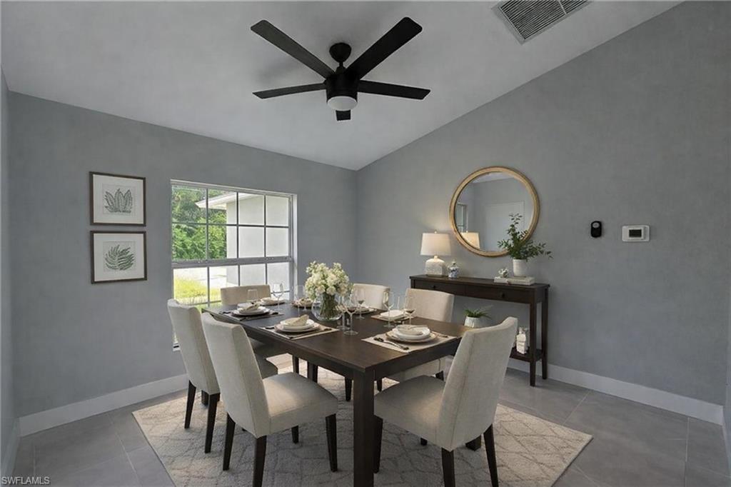 116 Ridgemont Drive Lehigh Acres, FL 33972 - Photo 18 of 45 a view of a dining room with furniture and a window