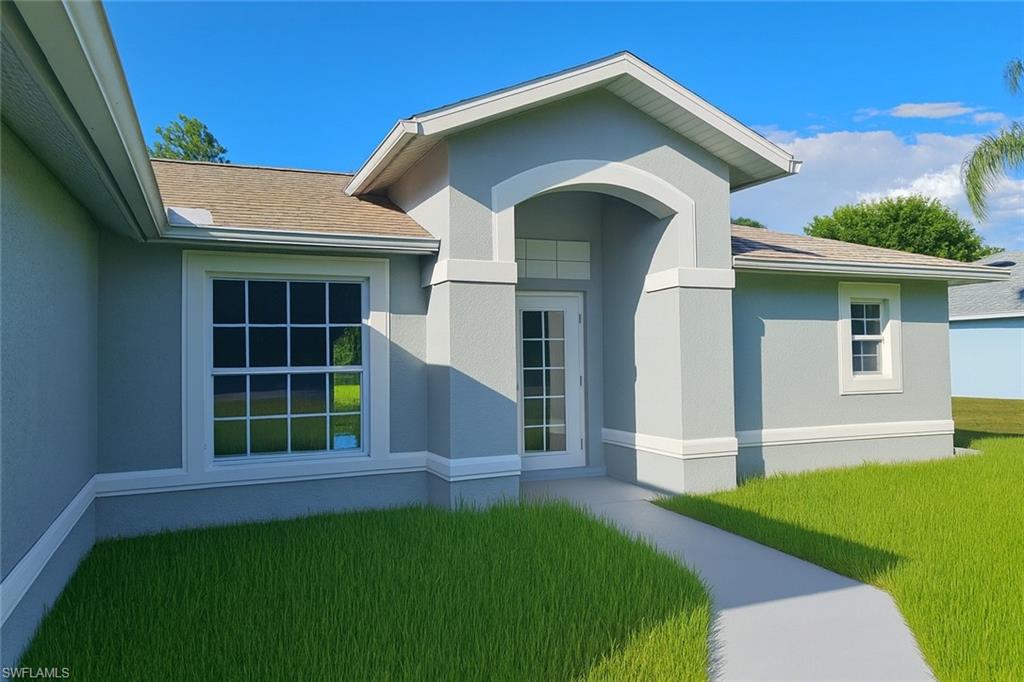 116 Ridgemont Drive Lehigh Acres, FL 33972 - Photo 2 of 45 a front view of a house with a garden