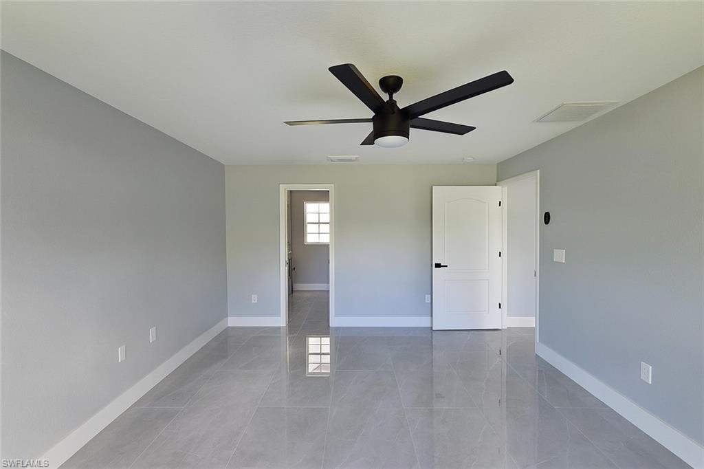 116 Ridgemont Drive Lehigh Acres, FL 33972 - Photo 22 of 45 a view of a livingroom with a ceiling fan and window