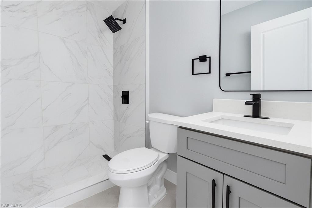 116 Ridgemont Drive Lehigh Acres, FL 33972 - Photo 31 of 45 a bathroom with a sink a toilet and shower