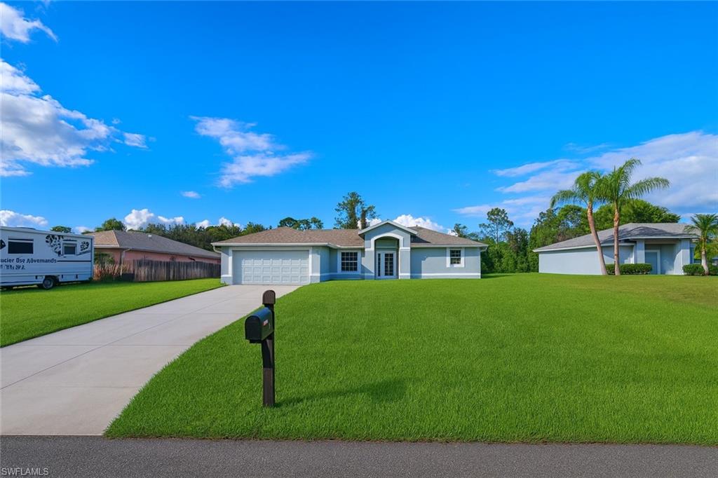 116 Ridgemont Drive Lehigh Acres, FL 33972 - Photo 40 of 45 a view of a house with a big yard plants and large trees