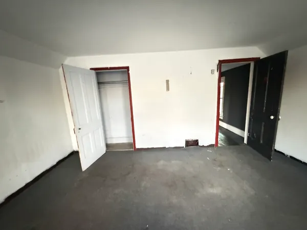 a view of a room with wooden floor and windows