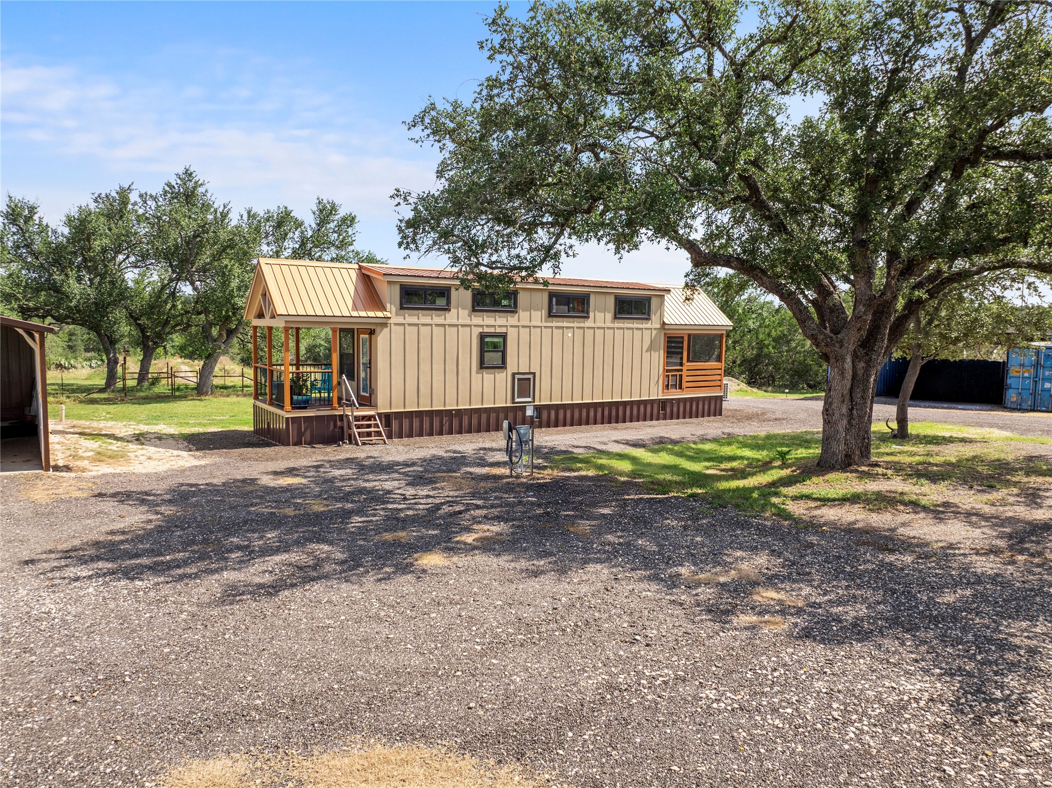 8200 Ranch Road 12 San Marcos, TX 78666 - Photo 31 of 40 A quaint residence with a welcoming front porch, shaded by mature trees.