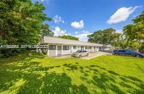 a front view of a house with swimming pool having outdoor seating