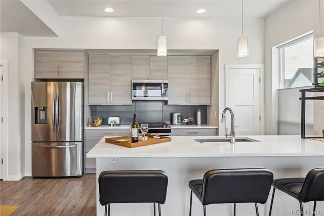 a kitchen with a refrigerator a stove a sink and a microwave