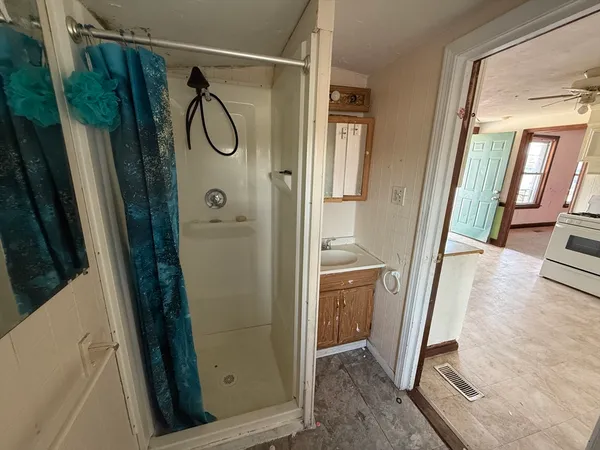 a bathroom with a shower and a sink