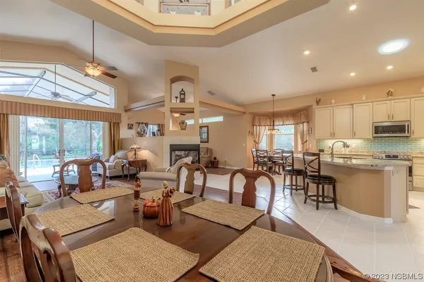 a living room with lots of furniture and kitchen view