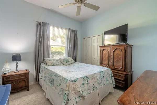 a bedroom with a bed and a television