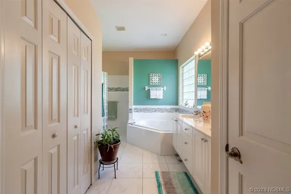 a bathroom with a tub shower and sink