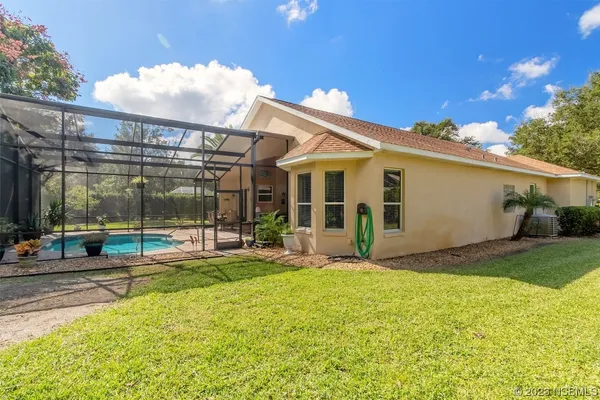 a view of a house with a backyard and porch