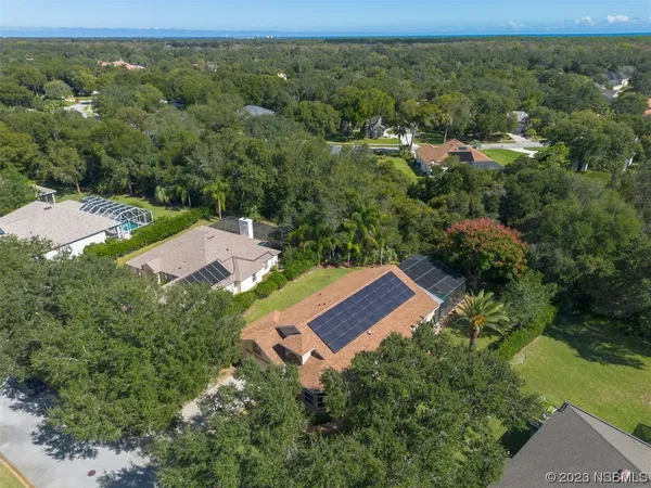 an aerial view of a house with a yard