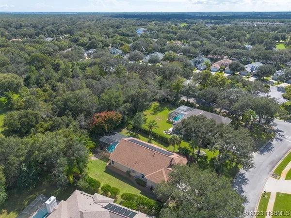 an aerial view of a house with a yard