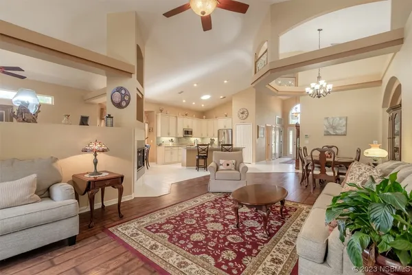a living room with furniture and a chandelier