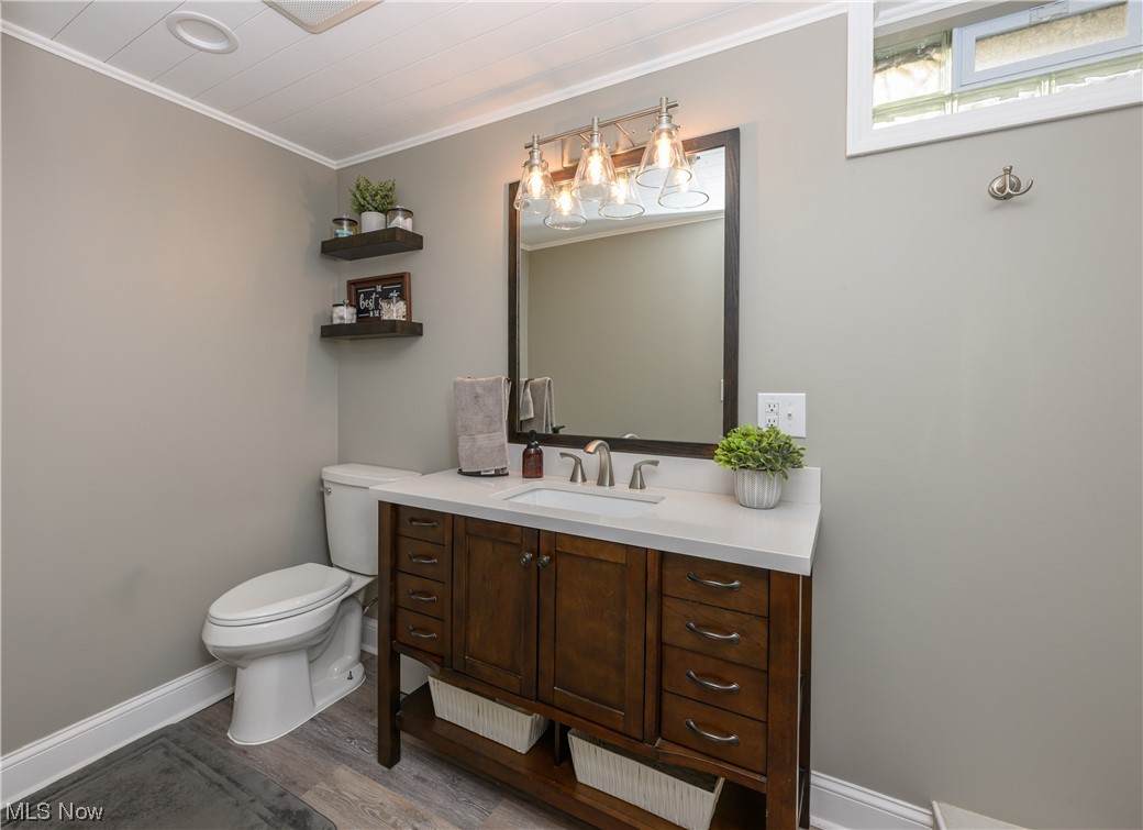 2383 Sunnybrook Road Mogadore, OH 44260 - Photo 26 of 31 Bathroom with mirror, hardwood floors, crown molding, and vanity