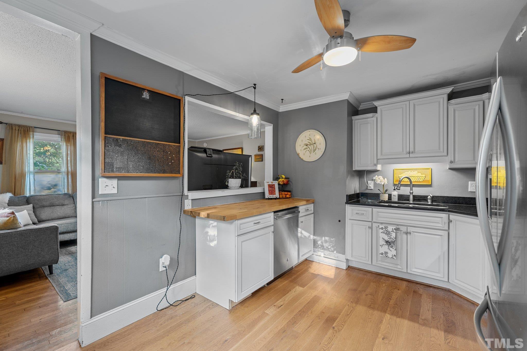 2615 Layden Street Raleigh, NC 27603 - Photo 11 of 34 a kitchen with stainless steel appliances granite countertop a stove a sink and a refrigerator