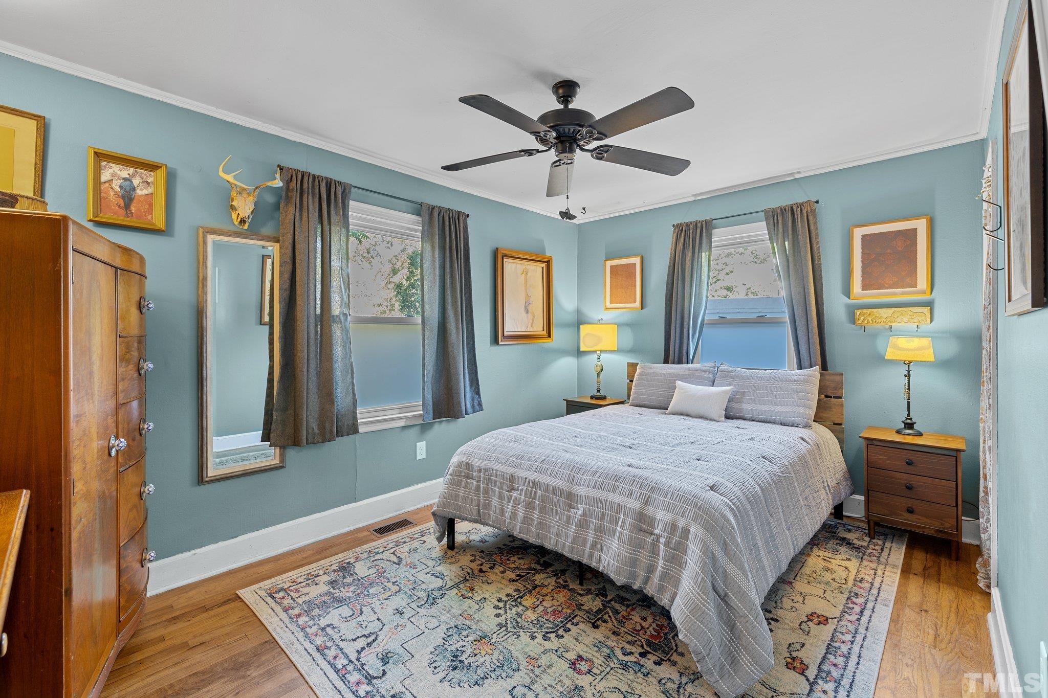 2615 Layden Street Raleigh, NC 27603 - Photo 14 of 34 a bedroom with a bed and a chandelier