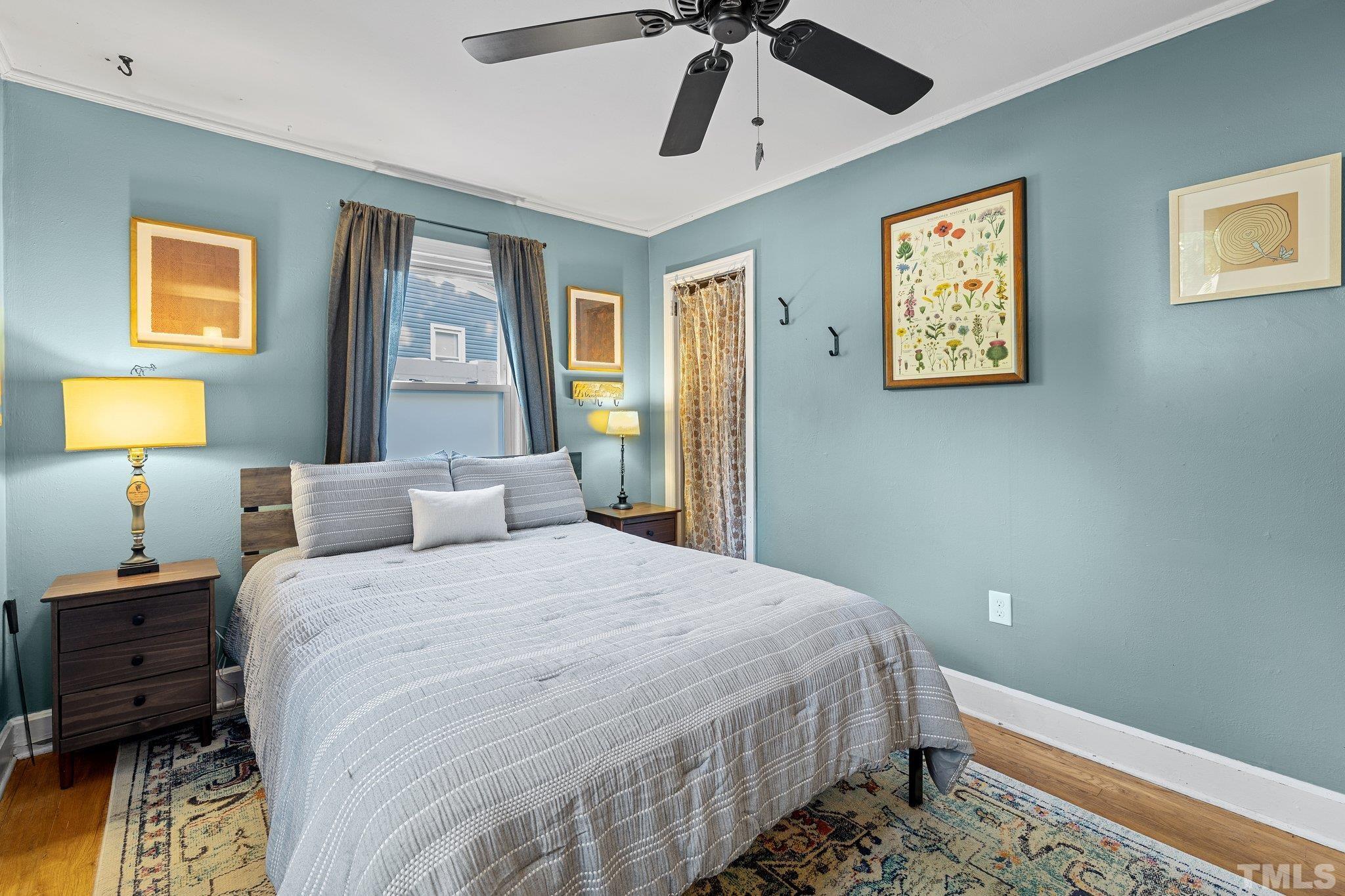 2615 Layden Street Raleigh, NC 27603 - Photo 15 of 34 a bedroom with a bed and wooden floor