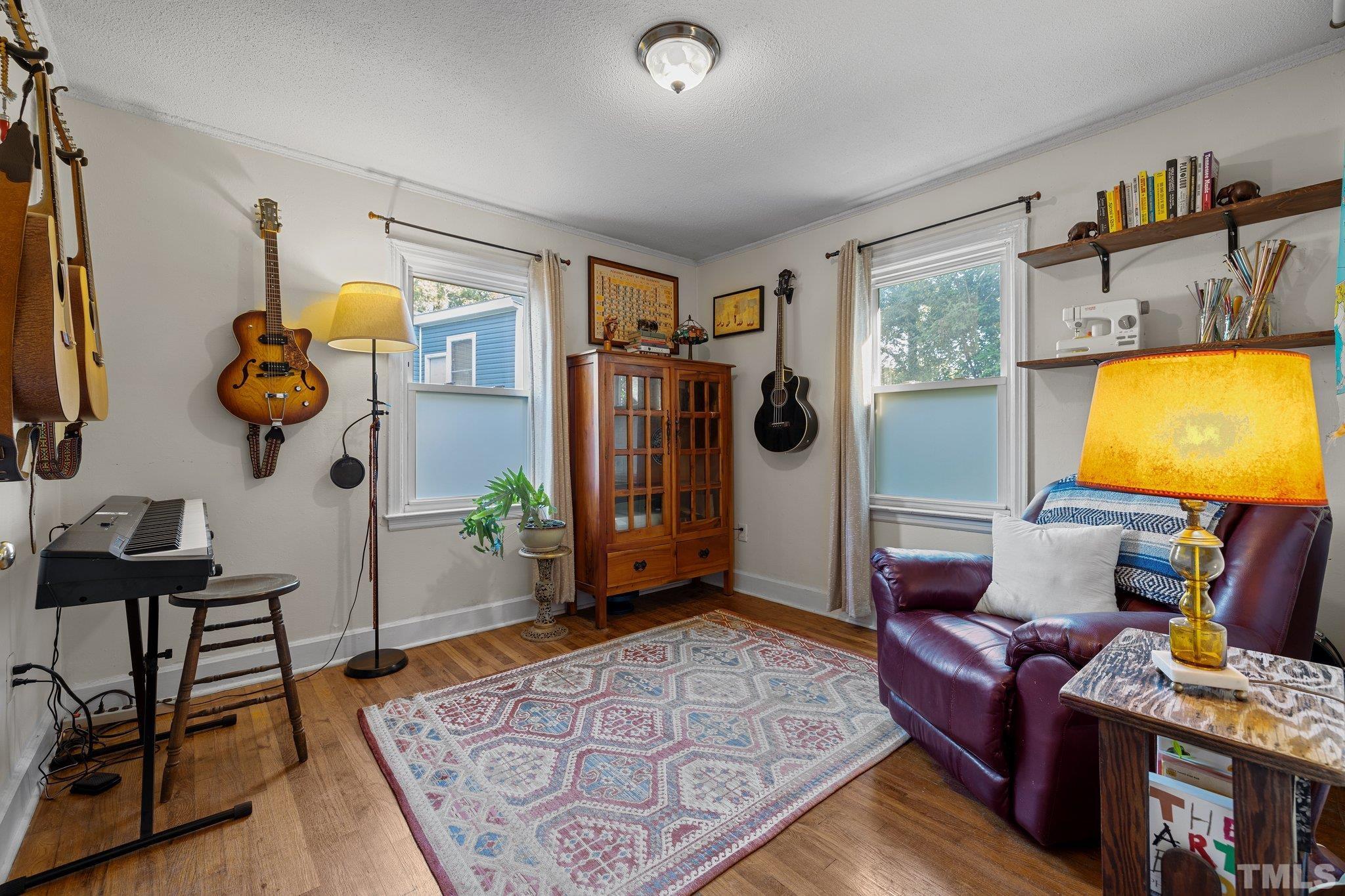 2615 Layden Street Raleigh, NC 27603 - Photo 17 of 34 a living room with furniture and a flat screen tv