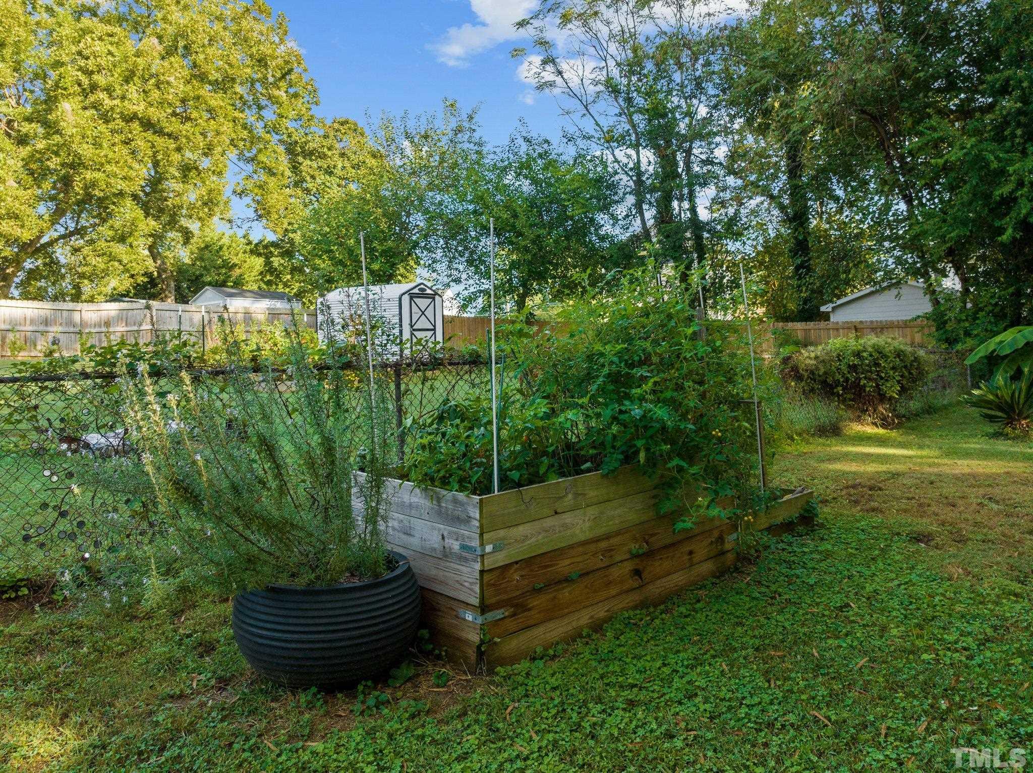 2615 Layden Street Raleigh, NC 27603 - Photo 24 of 34 a backyard of a house with lots of green space and outdoor seating